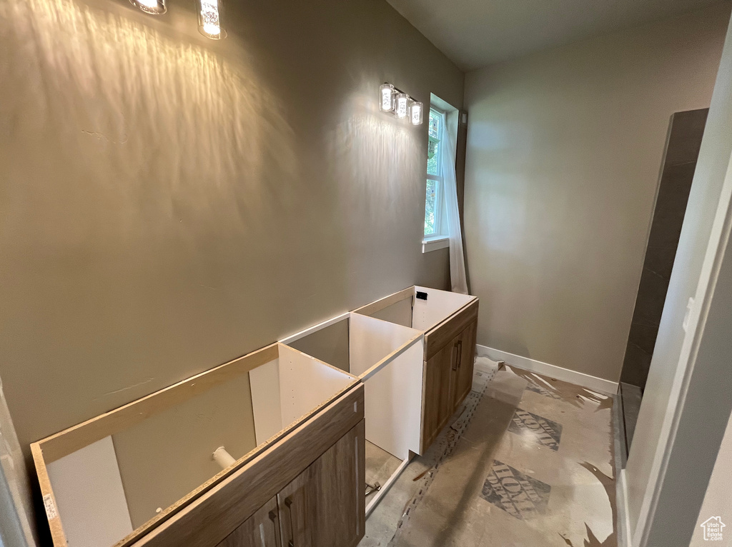 Bathroom featuring baseboards and vanity