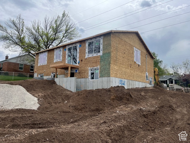 View of property exterior featuring fence