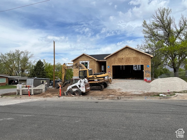 View of front facade featuring an attached garage and driveway