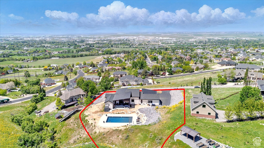 Aerial perspective of suburban area featuring property parcel outlined and a pool area