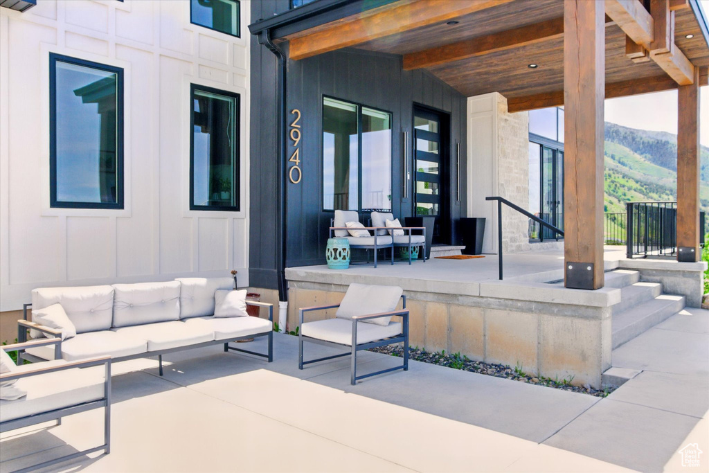 View of patio with an outdoor hangout area and a mountain view