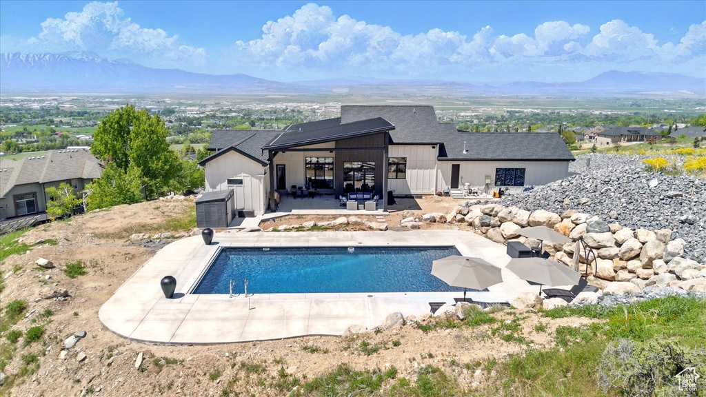 Outdoor pool featuring a mountain view, a patio area, and a gazebo