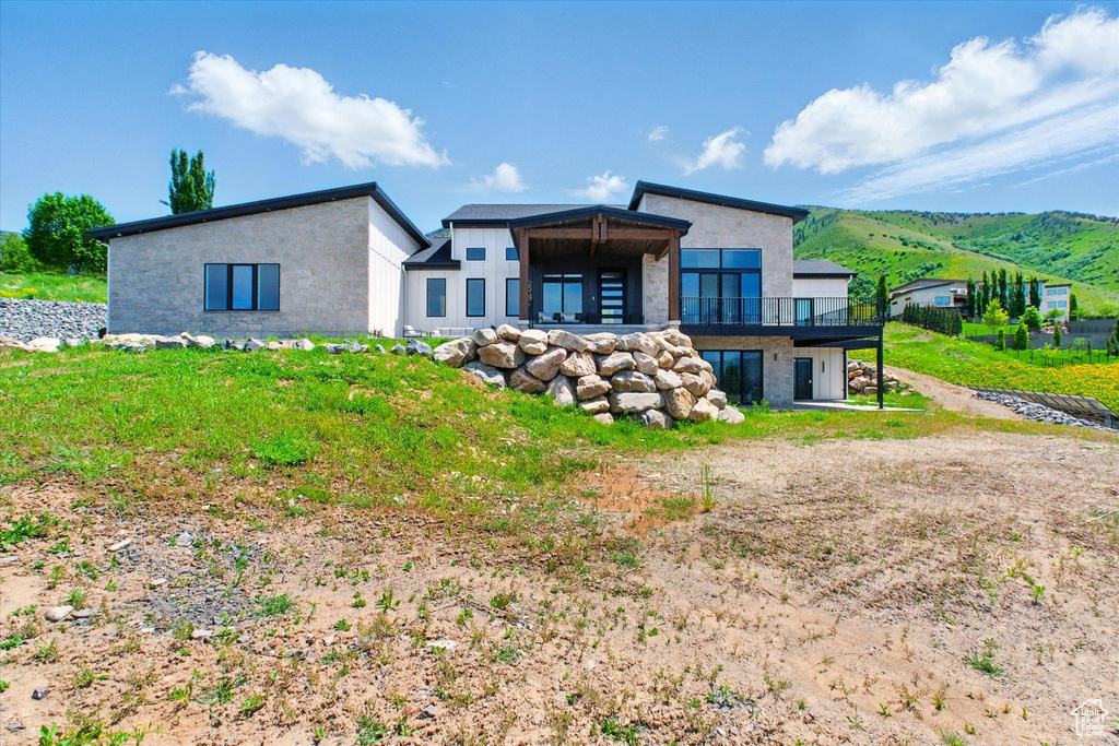 Rear view of property with a balcony