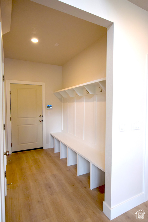 Mudroom featuring light wood finished floors and recessed lighting
