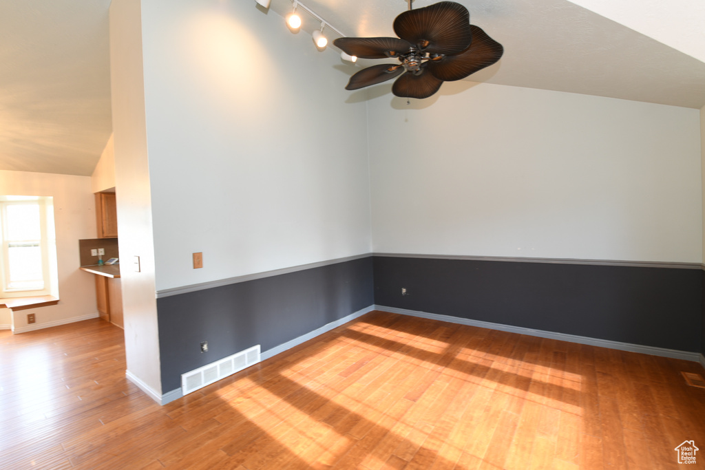 Bonus room with wood finished floors, ceiling fan, vaulted ceiling, and baseboards