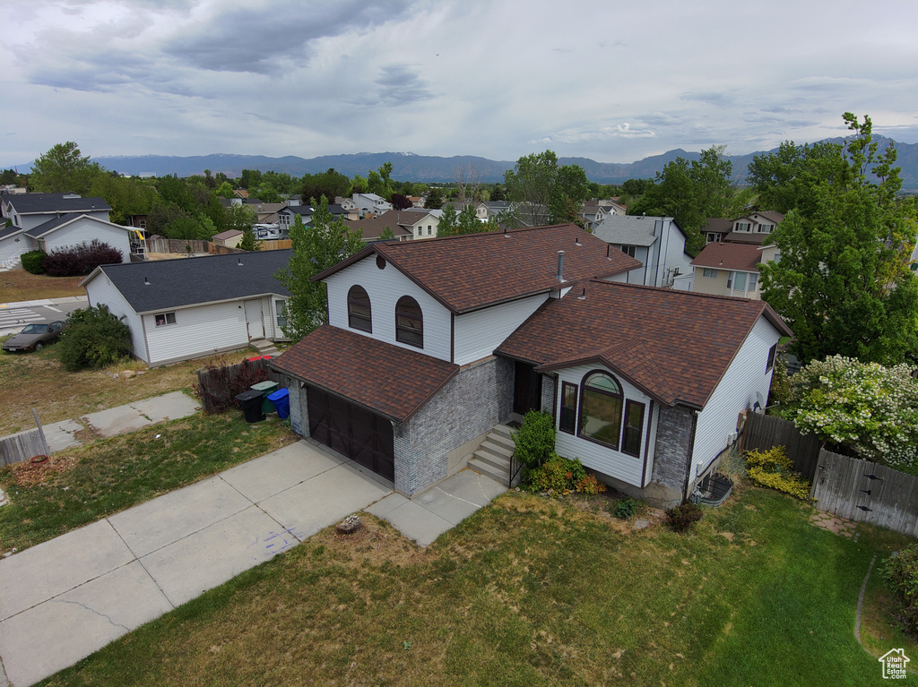 Aerial view of residential area featuring a mountainous background