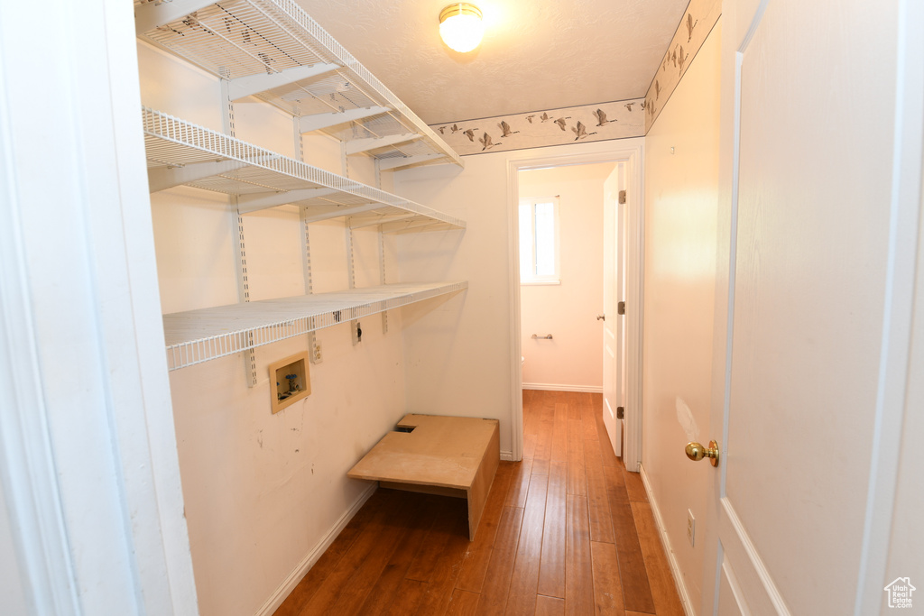 Laundry room with hookup for a washing machine, hardwood / wood-style flooring, and baseboards