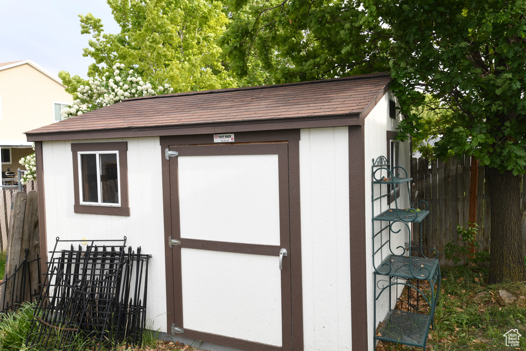 View of shed featuring fence