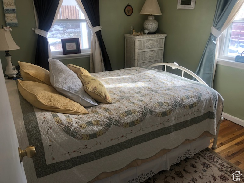 Bedroom featuring baseboards and wood finished floors