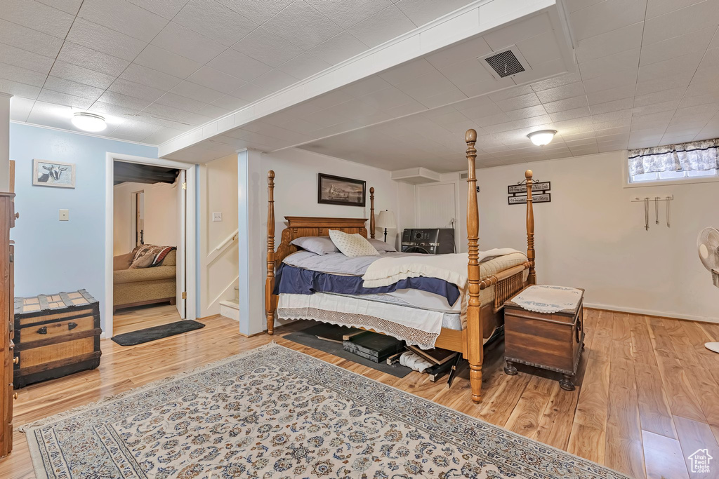 Bedroom with wood-type flooring and baseboards