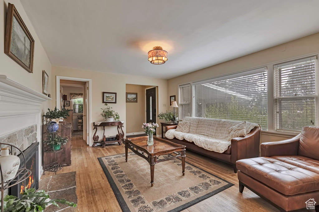 Living area featuring a fireplace with flush hearth and light wood-style flooring