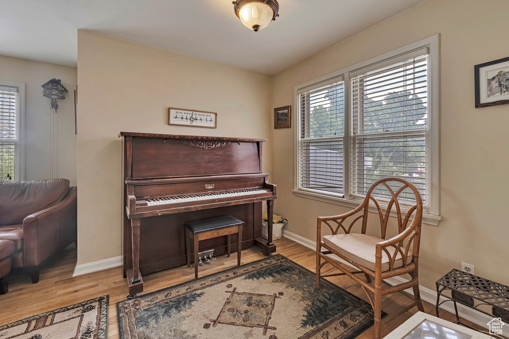 Living area featuring healthy amount of natural light, baseboards, and wood finished floors