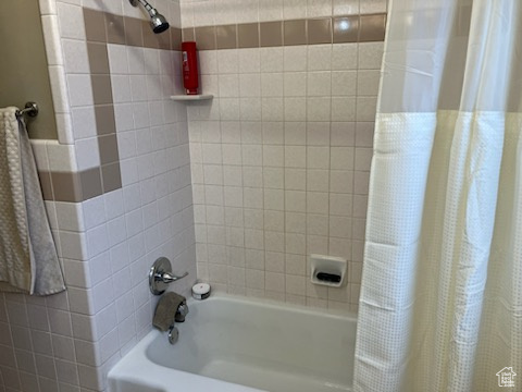 Bathroom with shower / bath combo with shower curtain
