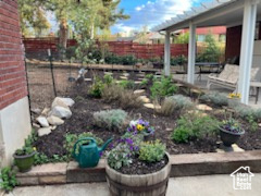 View of yard with fence and a patio