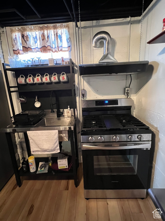 Kitchen with gas range and wood finished floors