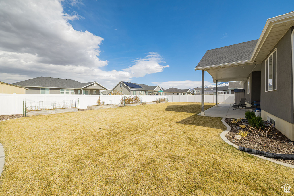 View of yard featuring a patio area, a residential view, and a fenced backyard