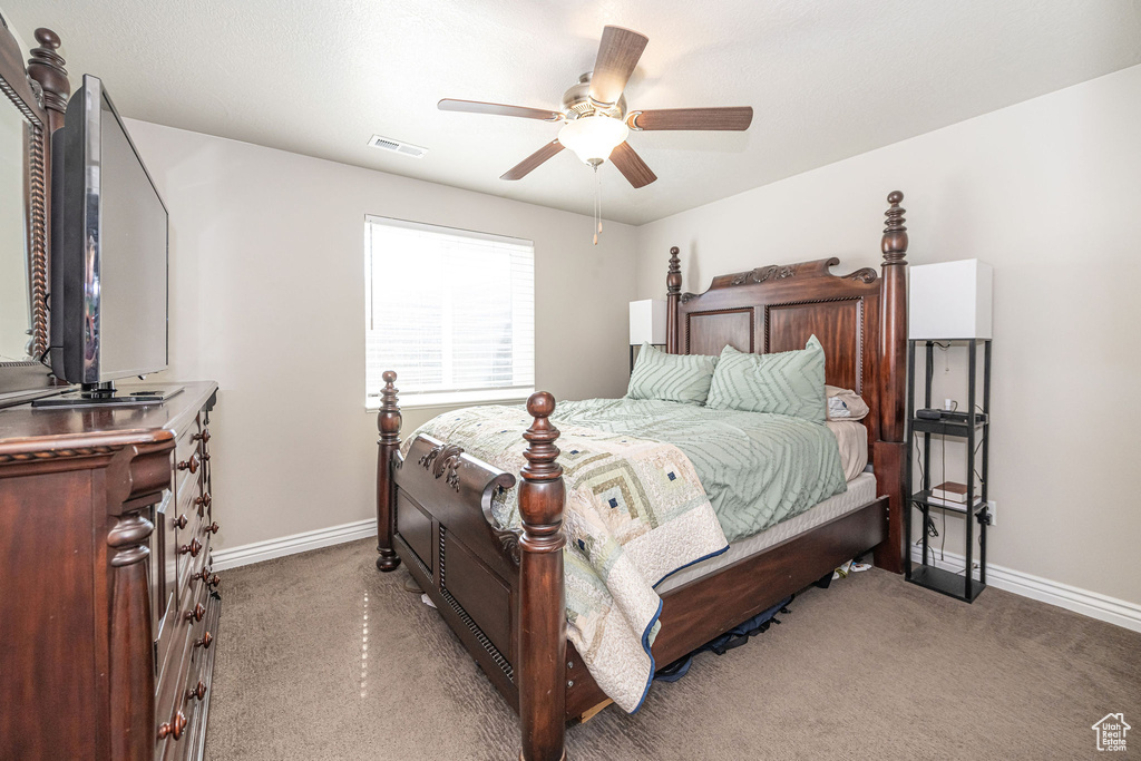Bedroom with visible vents, light colored carpet, and baseboards