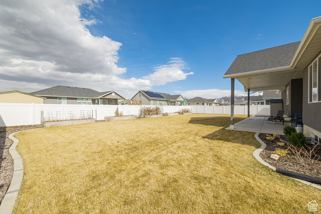 View of yard with a patio area, a residential view, and a fenced backyard