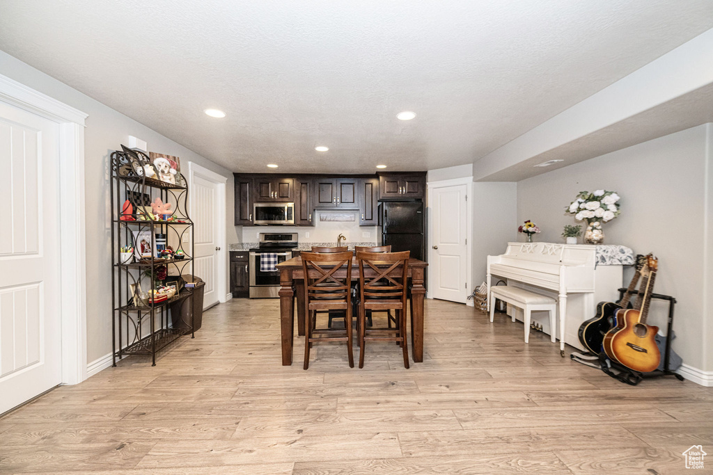 Dining area with light wood-style flooring, recessed lighting, and baseboards