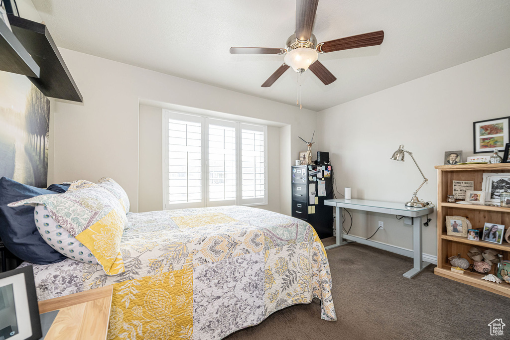 Bedroom featuring a ceiling fan and carpet floors