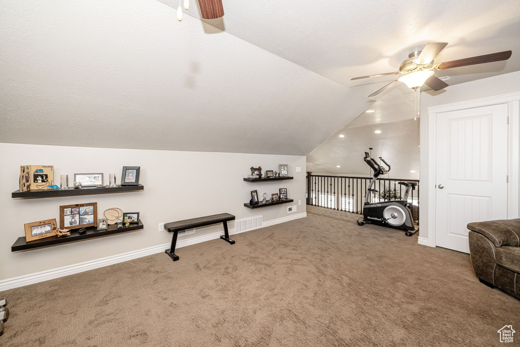 Living area with baseboards, lofted ceiling, a ceiling fan, and carpet floors