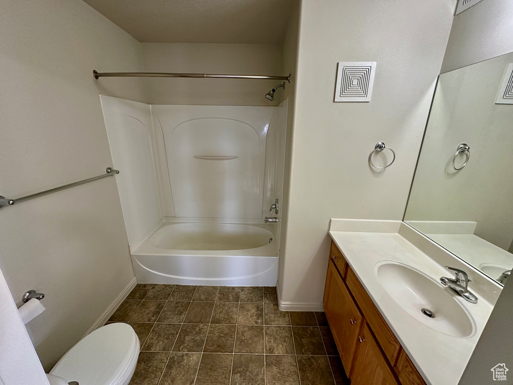 Full bathroom with toilet, shower / bathtub combination, tile patterned flooring, baseboards, and vanity