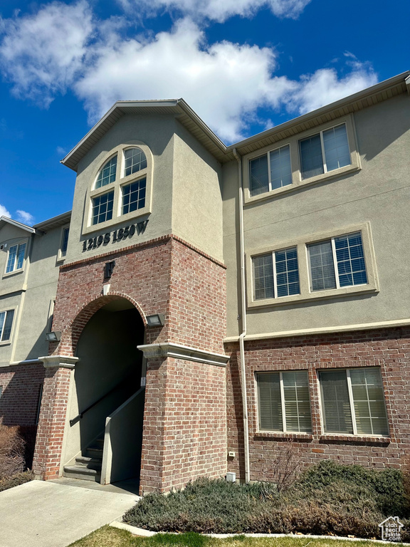 View of building exterior featuring driveway