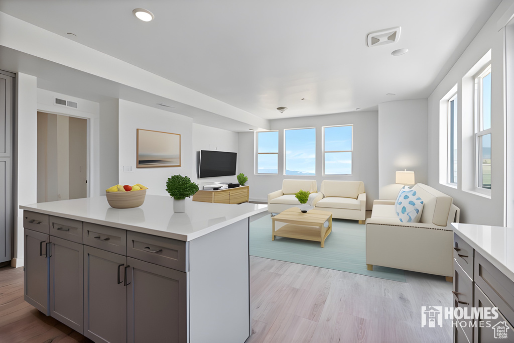 Kitchen featuring a wealth of natural light, open floor plan, and gray cabinetry
