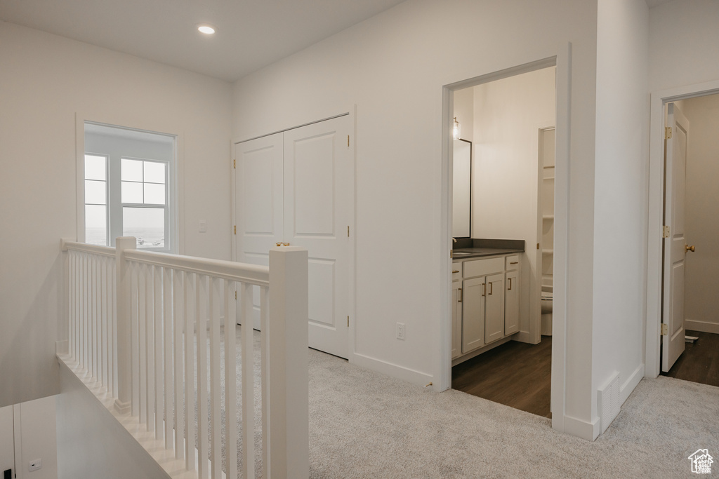 Hall featuring carpet flooring, an upstairs landing, recessed lighting, and baseboards