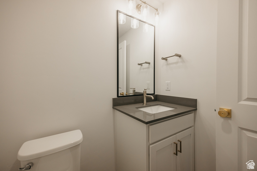 Half bath featuring toilet and vanity