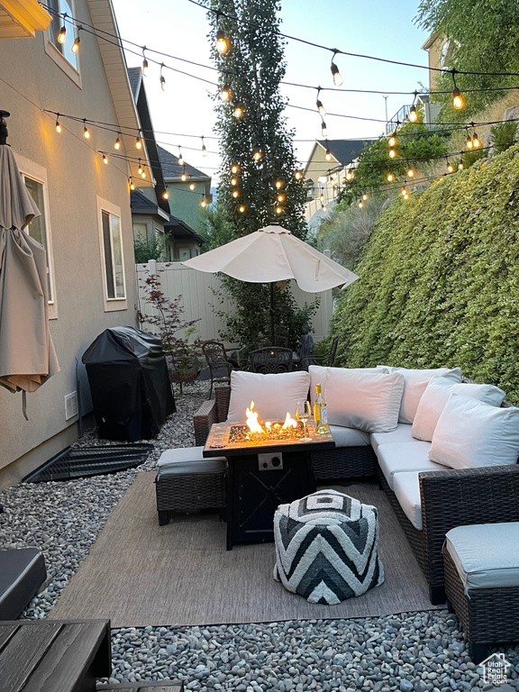 View of patio / terrace featuring grilling area and an outdoor living space with a fire pit