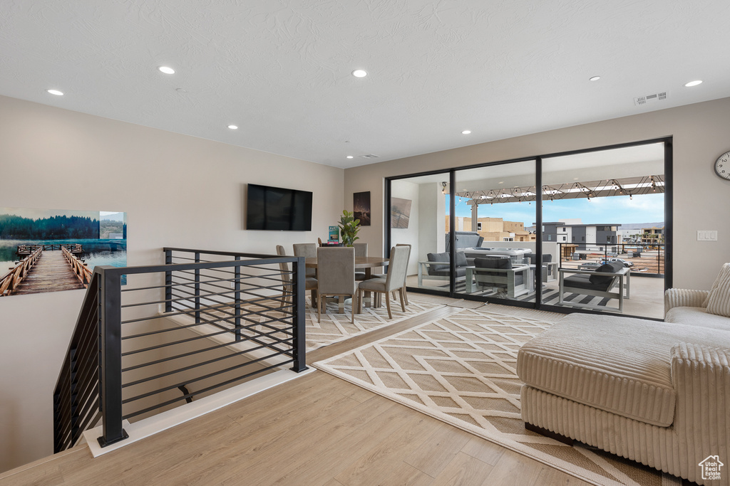 Living room featuring visible vents, recessed lighting, and wood finished floors