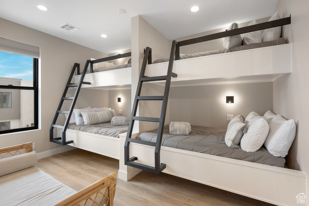 Bedroom with visible vents, recessed lighting, baseboards, and wood finished floors