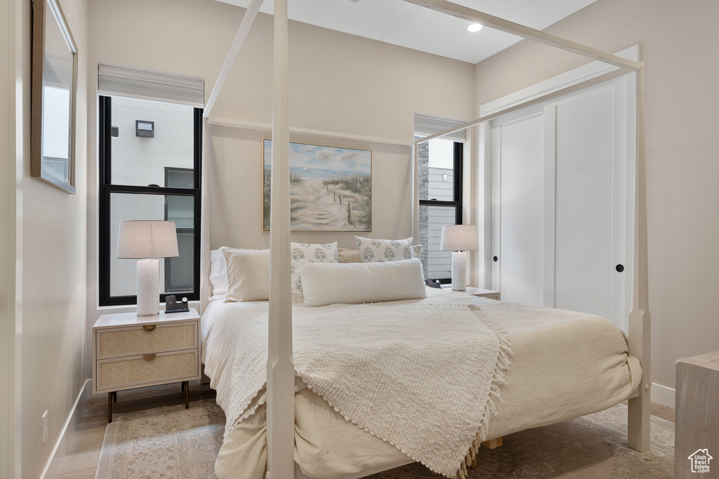 Bedroom with a closet, baseboards, and wood finished floors