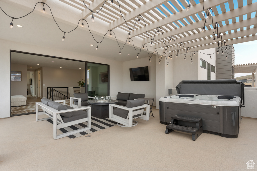 View of patio with an outdoor living space with a fire pit and a hot tub
