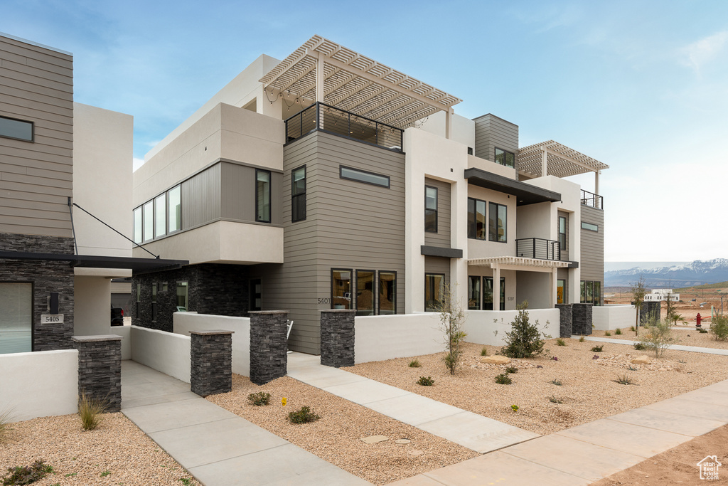 View of front of property with stone siding and stucco siding