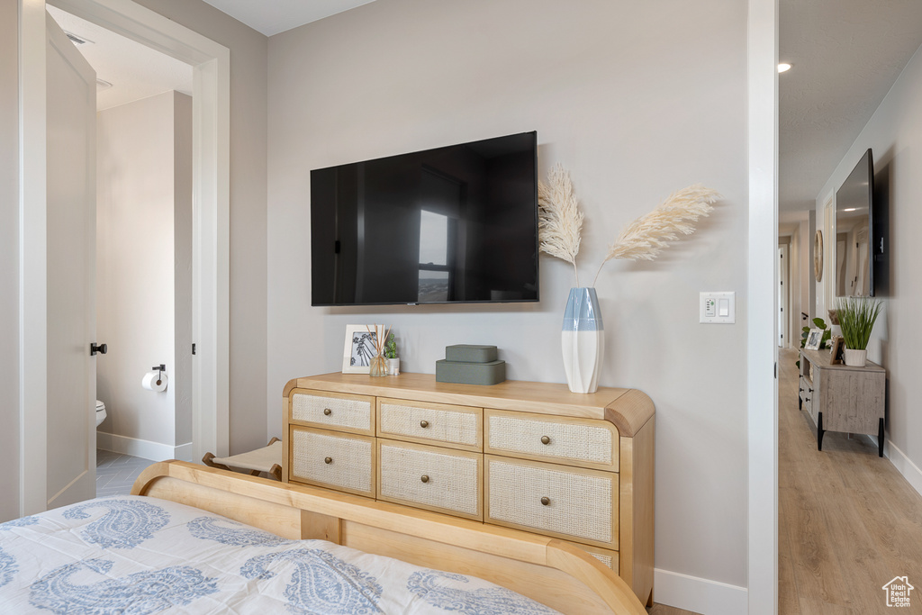 Bedroom featuring light wood-type flooring and baseboards