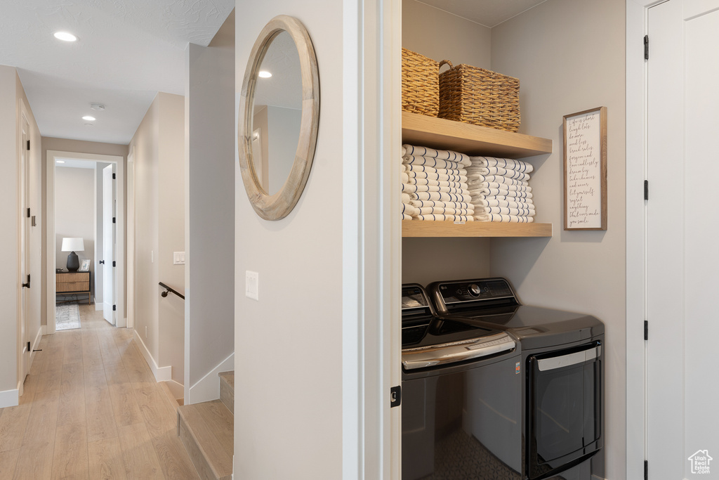 Clothes washing area with baseboards, light wood-type flooring, laundry area, recessed lighting, and separate washer and dryer