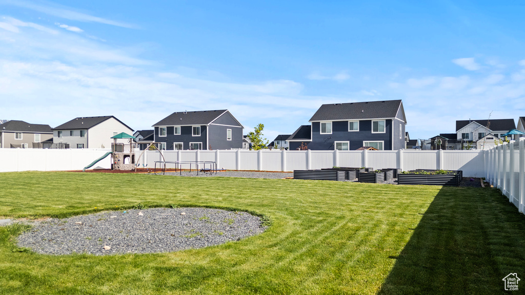 View of yard with a residential view and a playground