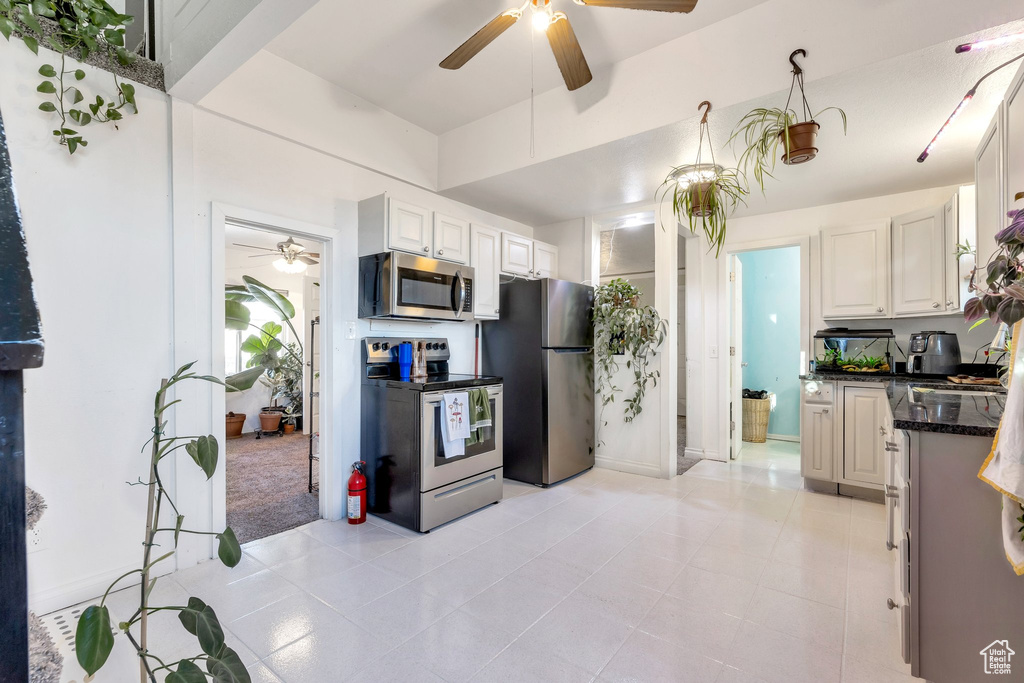 Kitchen featuring white cabinets, appliances with stainless steel finishes, and ceiling fan