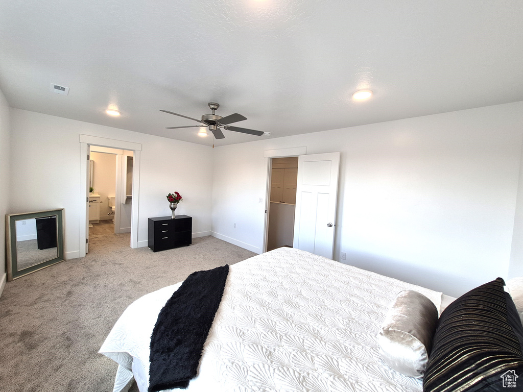 Bedroom with visible vents, light carpet, baseboards, and ceiling fan