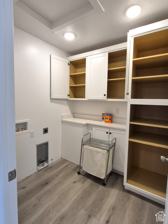 Laundry room with hookup for a washing machine, recessed lighting, cabinet space, electric dryer hookup, and light wood-type flooring