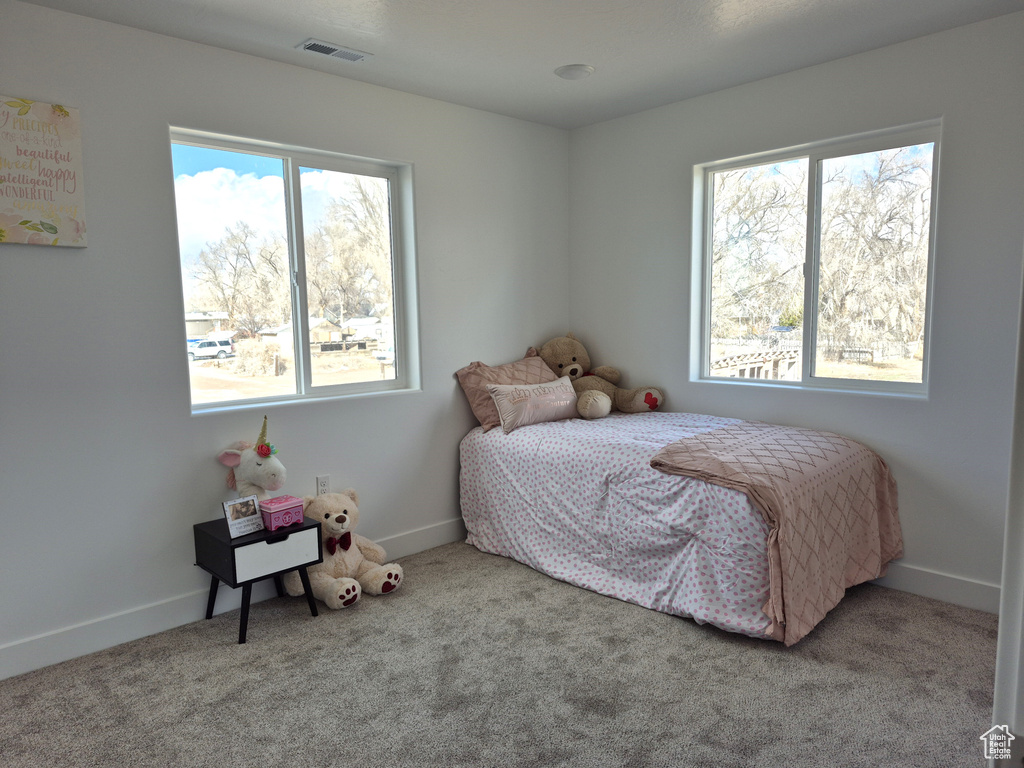 Bedroom featuring visible vents, baseboards, and carpet