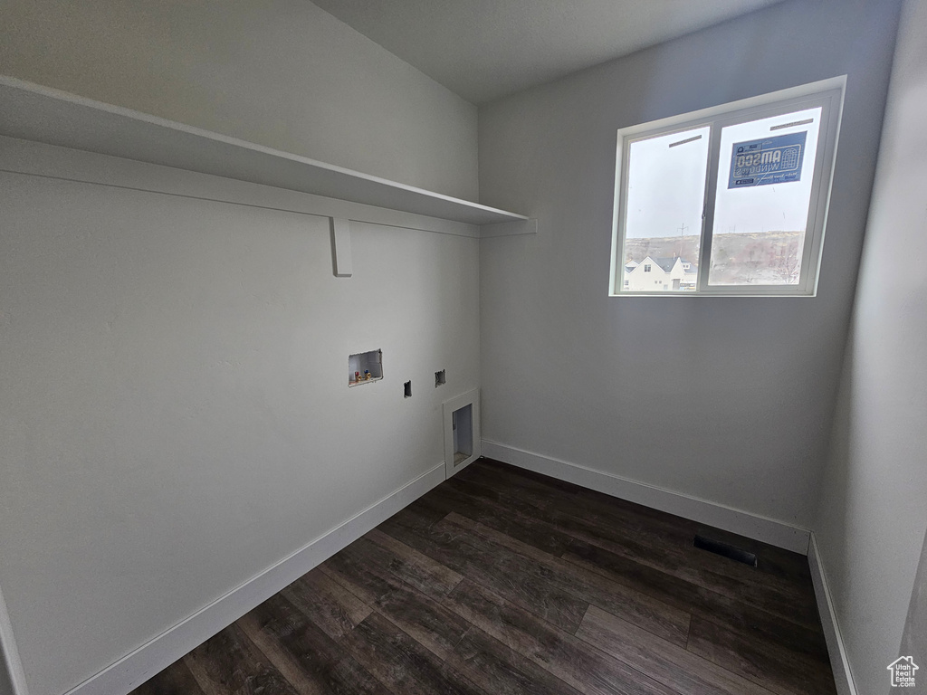 Clothes washing area with laundry area, hookup for a washing machine, dark wood-type flooring, and baseboards