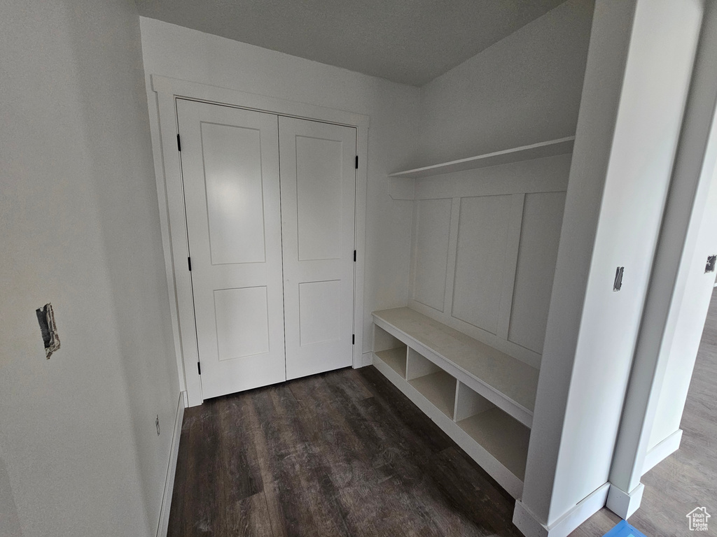 Mudroom with baseboards and wood finished floors