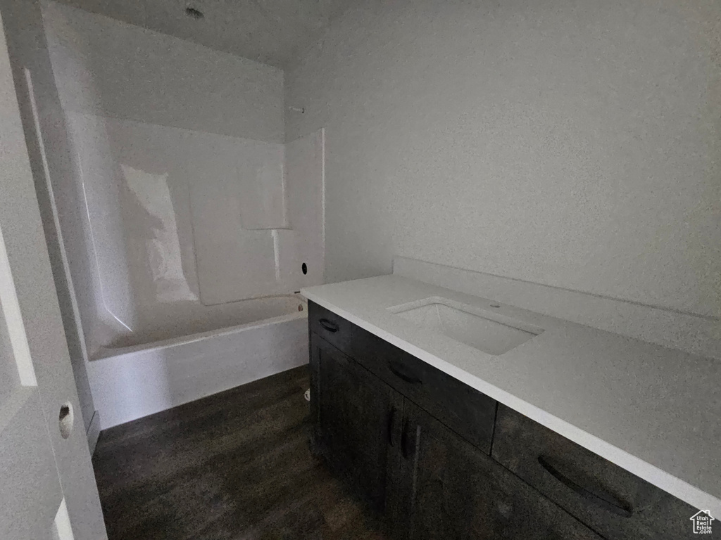 Full bath featuring shower / bathtub combination, wood finished floors, and vanity