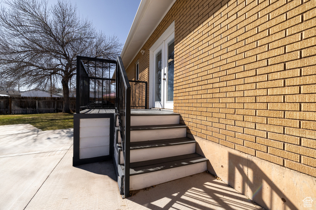 Exterior space with brick siding and fence