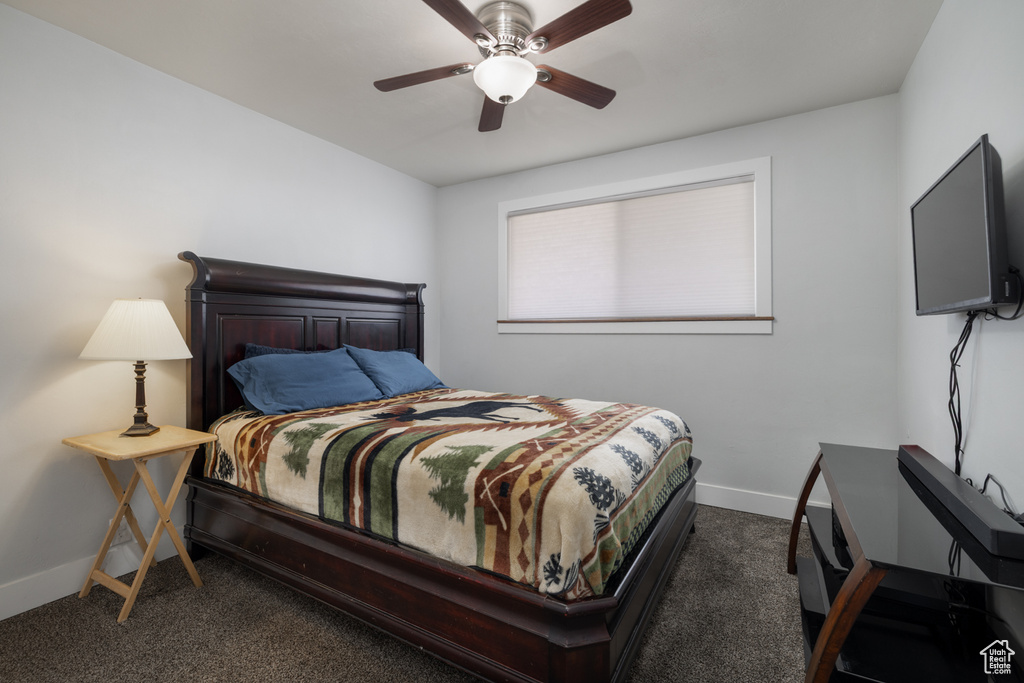 Bedroom with baseboards, ceiling fan, and carpet flooring