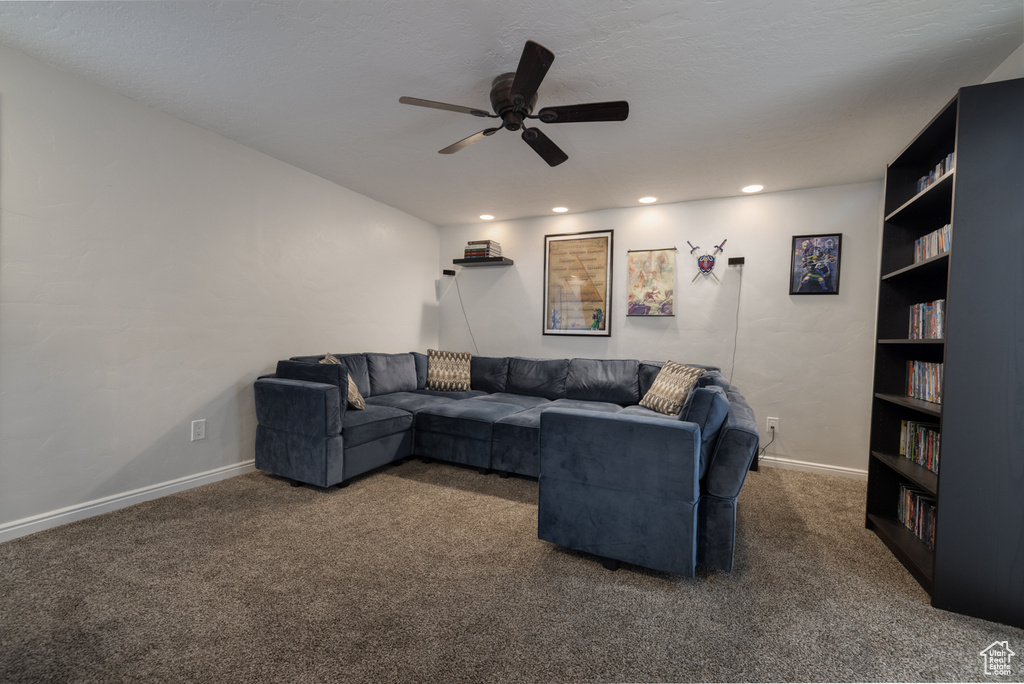 Carpeted living area with recessed lighting, baseboards, and ceiling fan