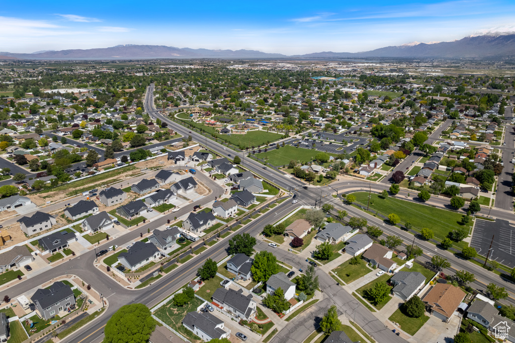 Aerial overview of property's location featuring mountains and nearby suburban area